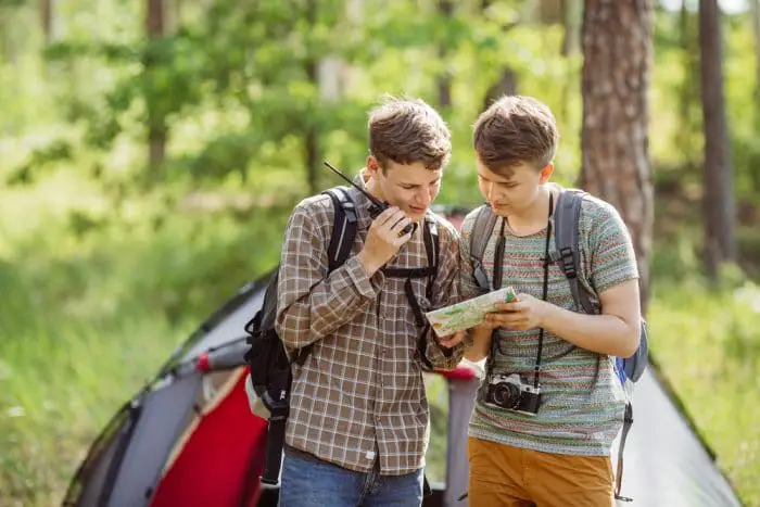 Two man using survival radio