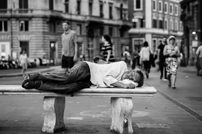 man sleeping at the middle of the street