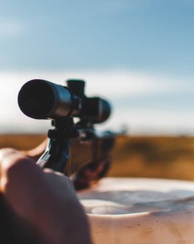 Man Holding Gun on Savannah