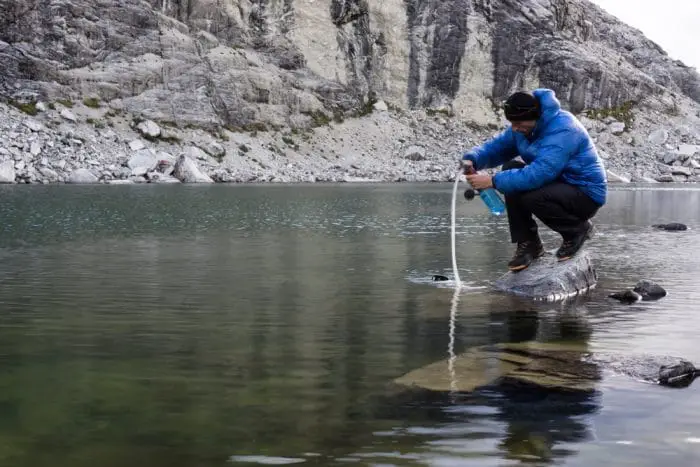 Man Filtering Water from Lake