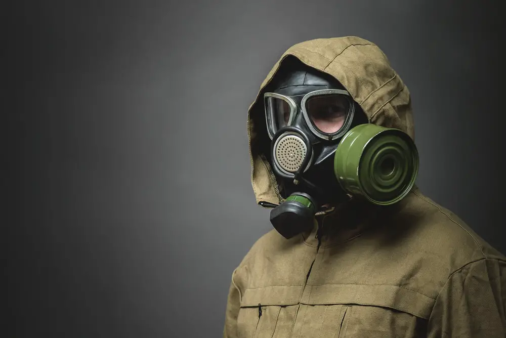 Man,In,Gas,Mask,Close,Up,On,Gray,Background.